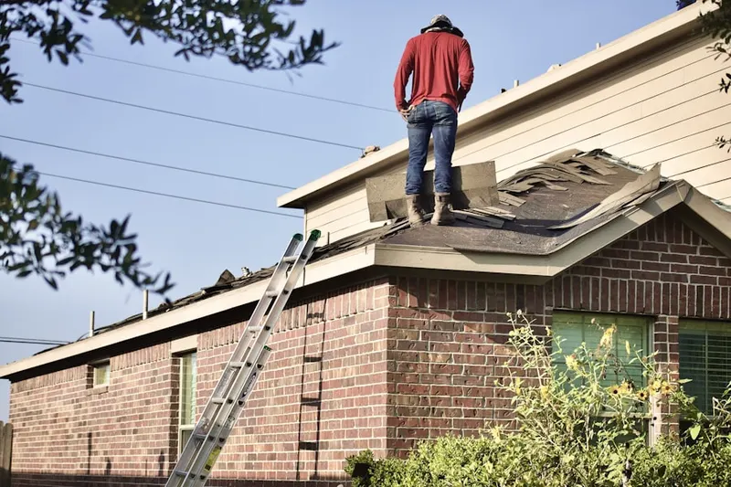 Professional roofer working on a residential roof in Summit View Woods